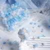 A close-up of blue and white camellia resin flower fillers scattered on a white surface.
