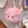 A pink fluffy plush pig keychain attached to a white fabric bag.