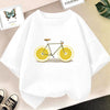 White graphic t-shirt featuring a yellow bicycle with lemon wheels on a light background