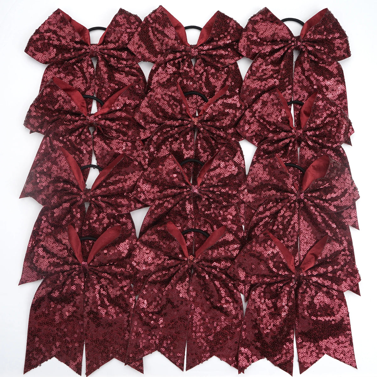 A pack of twelve glitter sequin pigtail bows for girls in a deep maroon color.
