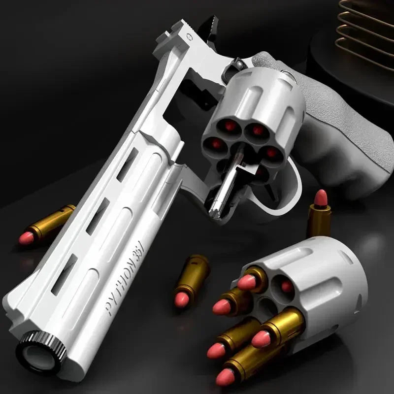 A white spring-powered revolver dart blaster with soft foam ammunition and a grip shown in a close-up view.