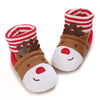 A pair of adorable animal-themed baby first walker shoes featuring a brown bear design and a red and white striped knitted cu
