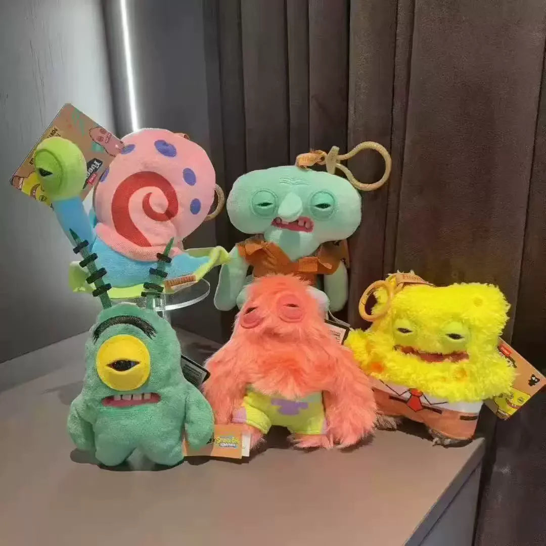 A collection of colorful monster plush keychains featuring characters inspired by Fuggler and SpongeBob SquarePants.