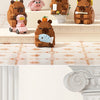 A set of cute capybara micro building blocks in various earthy and pastel colors displayed on a shelf.