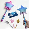 A collection of 3D printed magic wands shaped like stars, featuring iridescent colors and credit card holders.