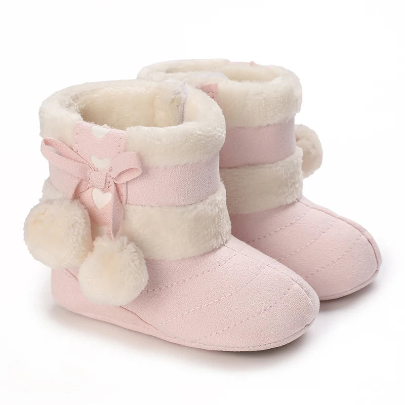 Pink faux fur baby first walker shoes with a bow detail and striped cuff