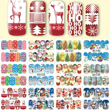 A collection of Christmas themed nail art stickers featuring reindeer, snowflakes, and festive designs for manicures.