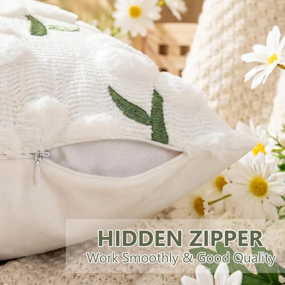 White knitted pillow cover with embroidered green leaves and a hidden zipper detail