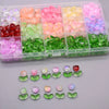 A clear plastic container holds various colored glass beads in compartments.