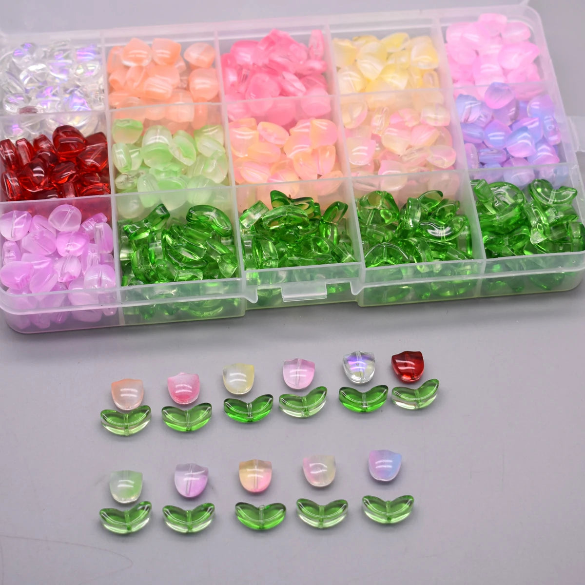 A clear plastic container holds various colored glass beads in compartments.