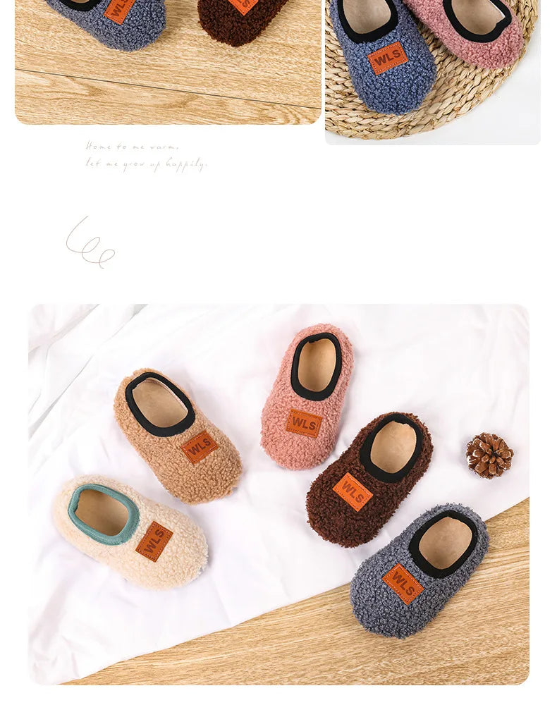 A collection of cozy plush baby slippers in various colors including blue, brown, and pink, shown on a woven mat.