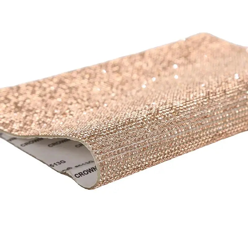 Roll of sparkling rose gold rhinestone adhesive tape for DIY crafts and decor