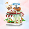 A miniature city shop building block set featuring a coffee cafe storefront with signage and outdoor seating.