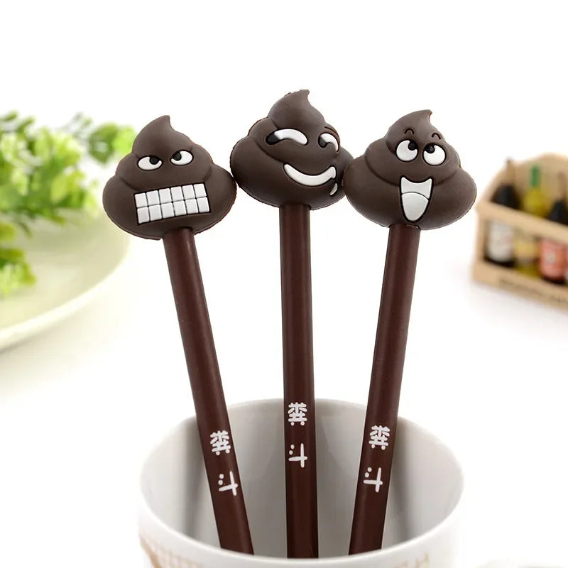A pack of three dark brown novelty cartoon poop-shaped gel pens standing in a white cup.