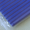 A close-up view of a blue polymer clay kit with ribbed texture resting on a light surface.