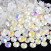 A close-up view of clear and iridescent sparkling crystal flatback rhinestones for nail art and crafts.