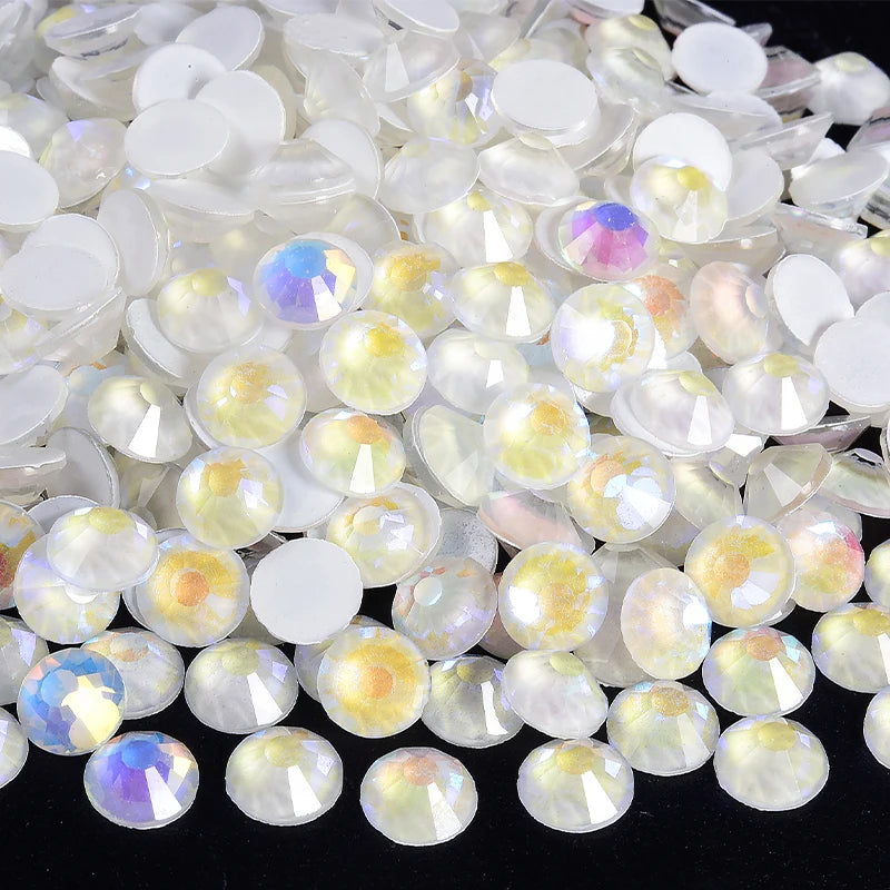 A close-up view of clear and iridescent sparkling crystal flatback rhinestones for nail art and crafts.