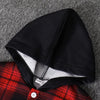 Black fleece-lined hooded shirt and plaid print shirt laid on gray fabric.