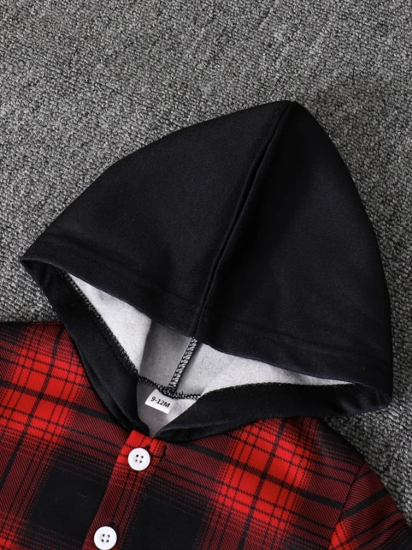 Black fleece-lined hooded shirt and plaid print shirt laid on gray fabric.