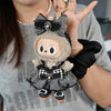 A handmade plush doll resembling a character with black and white flannel outfit details being held by a person.