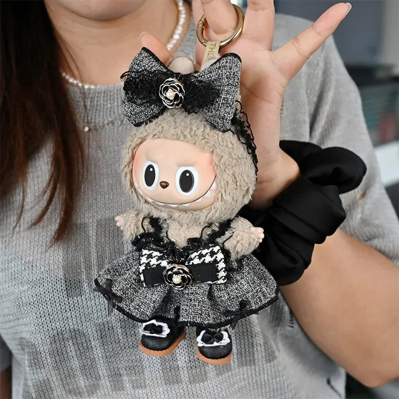 A handmade plush doll resembling a character with black and white flannel outfit details being held by a person.
