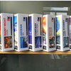 A row of six boxed jigsaw puzzles featuring fantasy and nature scenes, including Rainy Night Lover, Aegean Sea, Fantasy Train