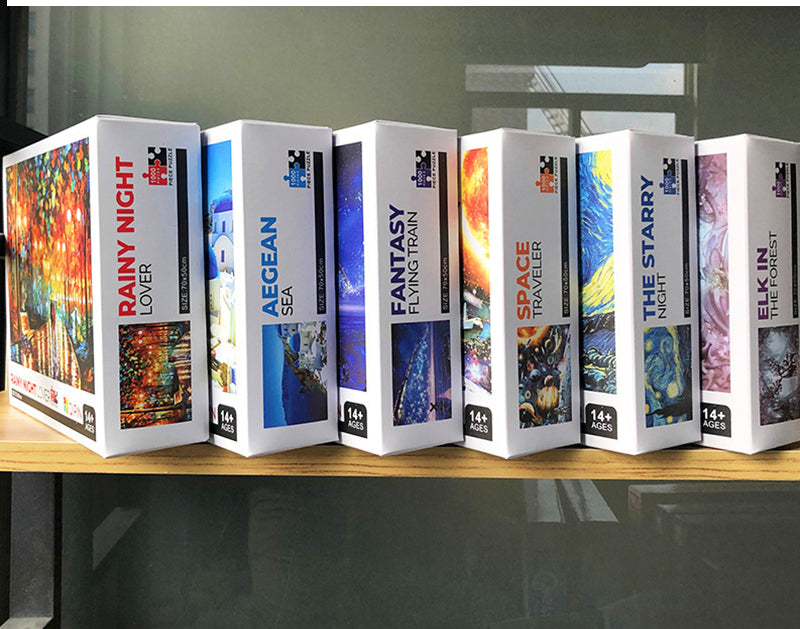 A row of six boxed jigsaw puzzles featuring fantasy and nature scenes, including Rainy Night Lover, Aegean Sea, Fantasy Train