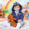 A baby wearing a blue hoodie sitting on a rug with an orange stuffed animal.