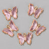 A set of four pink crystal butterfly charm beads for jewelry making