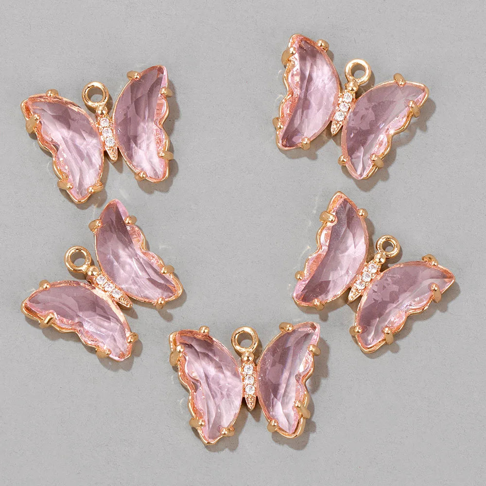 A set of four pink crystal butterfly charm beads for jewelry making