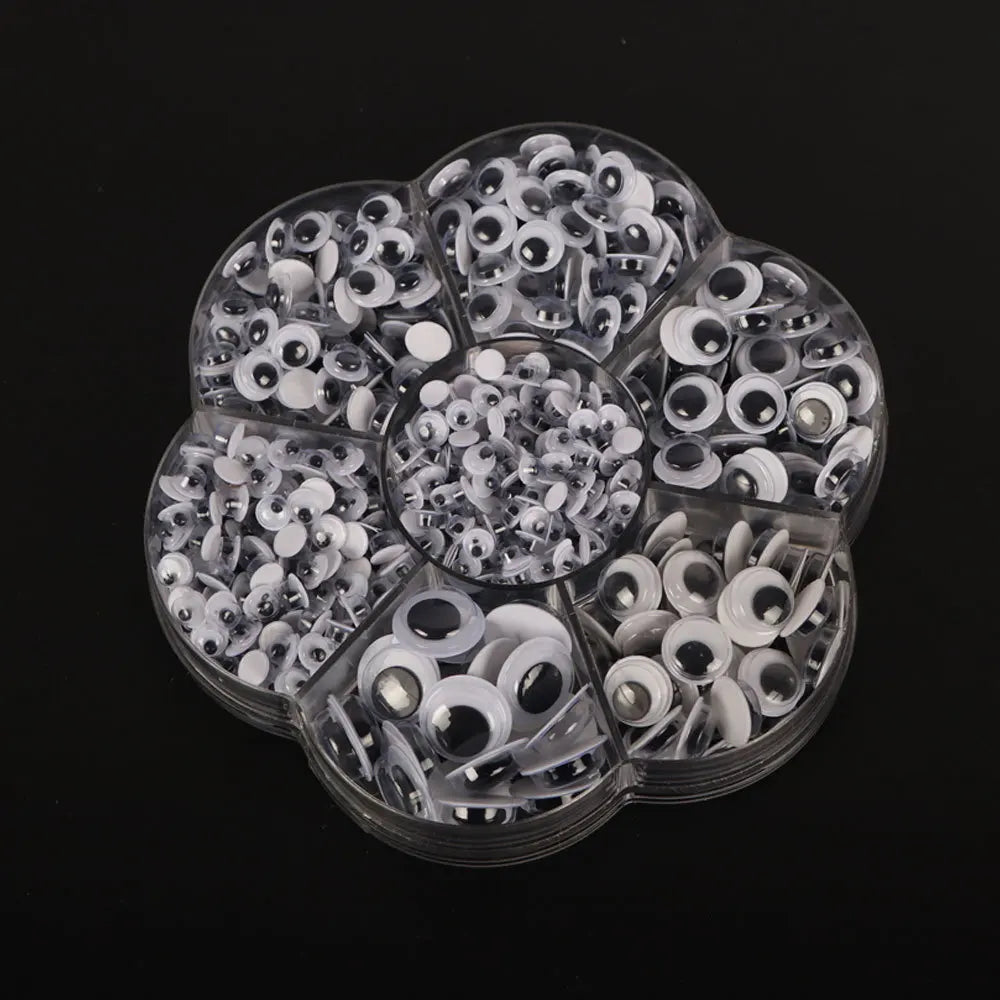 A clear plastic container filled with various self-adhesive moving eyes for crafts and DIY decorations.