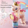 A pink unicorn toy bubble gun is shown spraying colorful bubbles and light in a rainbow arc.