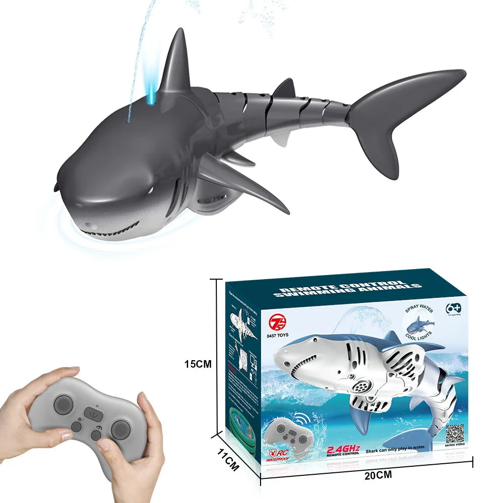 A gray shark toy is shown alongside its remote control and packaging box.