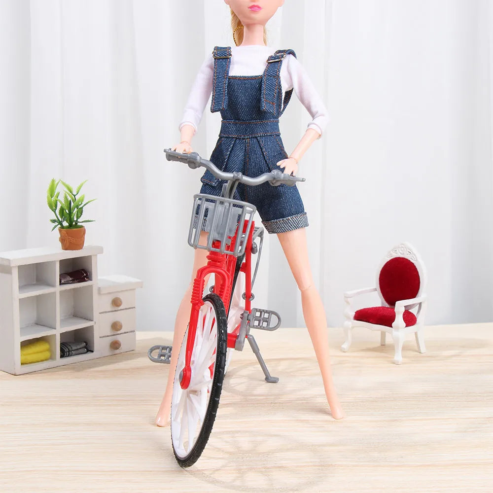 A mini doll wearing a denim overalls set and white t-shirt standing next to a red bicycle.