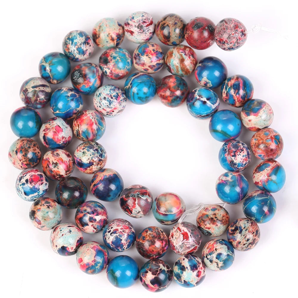 A circular arrangement of natural sea sediment jasper and turquoise beads for jewelry making