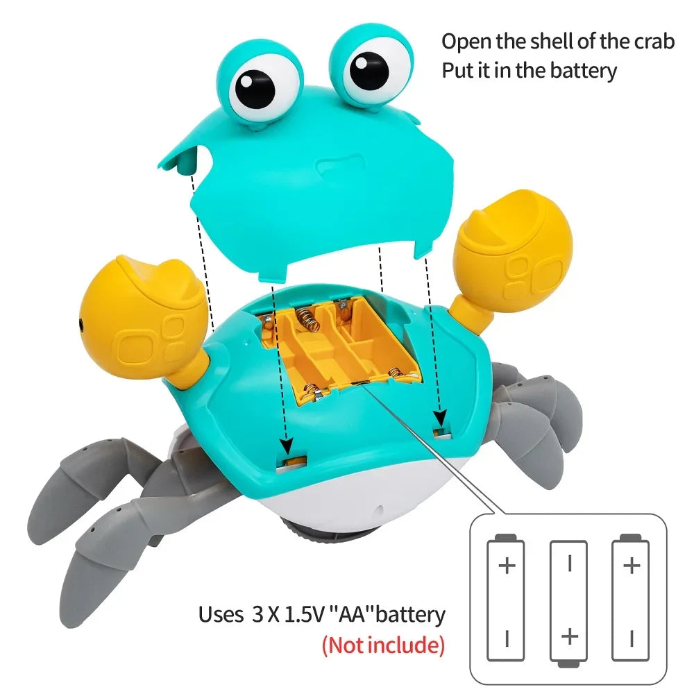 A blue interactive crab toy with yellow claws and an open shell, showing the battery compartment.