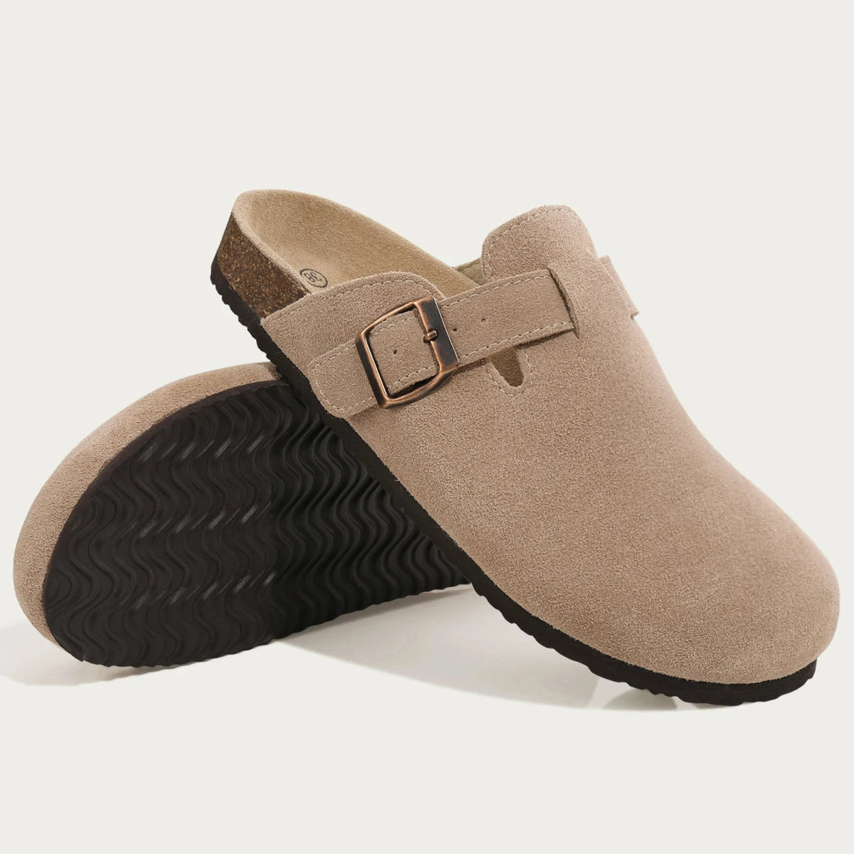 Tan suede cork mule with a brown leather strap and textured sole