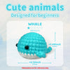 A light blue whale amigurumi crochet project displayed on a white background with difficulty rating and size measurements.
