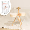 A wooden kids drum set with two drums and mallets displayed on a light beige fabric.