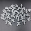 A pile of clear acrylic cross beads for jewelry making