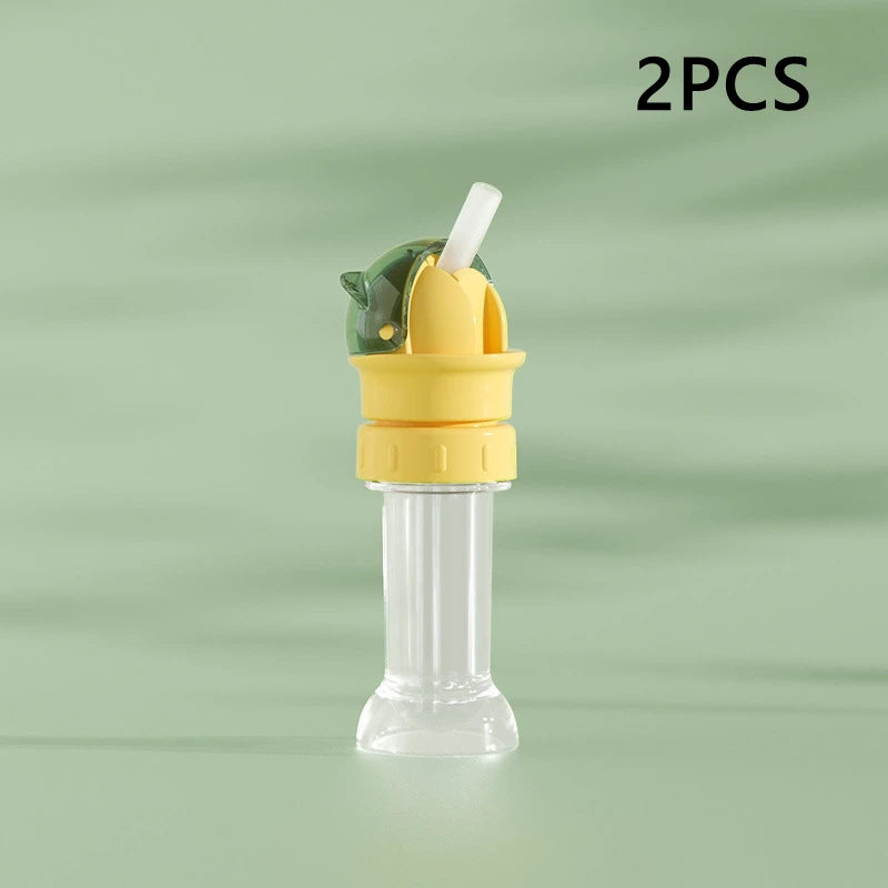 Two pieces of a yellow and green anti-choking straw and bottle cap converter for kids