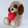 A fluffy brown and tan plush bear toy with a red heart print on its chest.