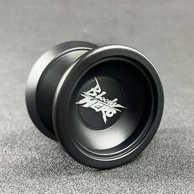 A close-up view of a black aluminum alloy yo-yo with a silver bearing and a Bloody Hero logo etched on the surface.