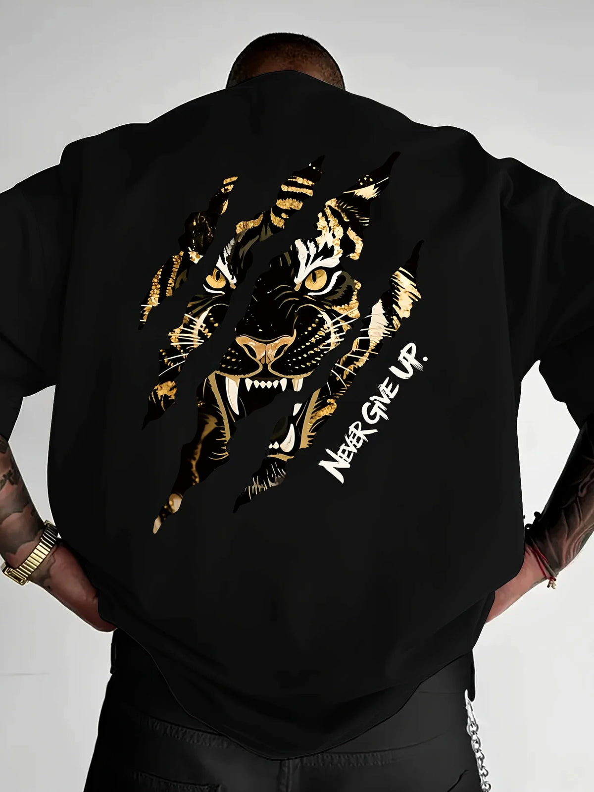 Black graphic cotton t-shirt featuring a gold tiger claw design with the text Never Give Up
