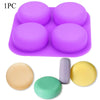 A purple silicone soap mold with four cavities and several colored soap discs.