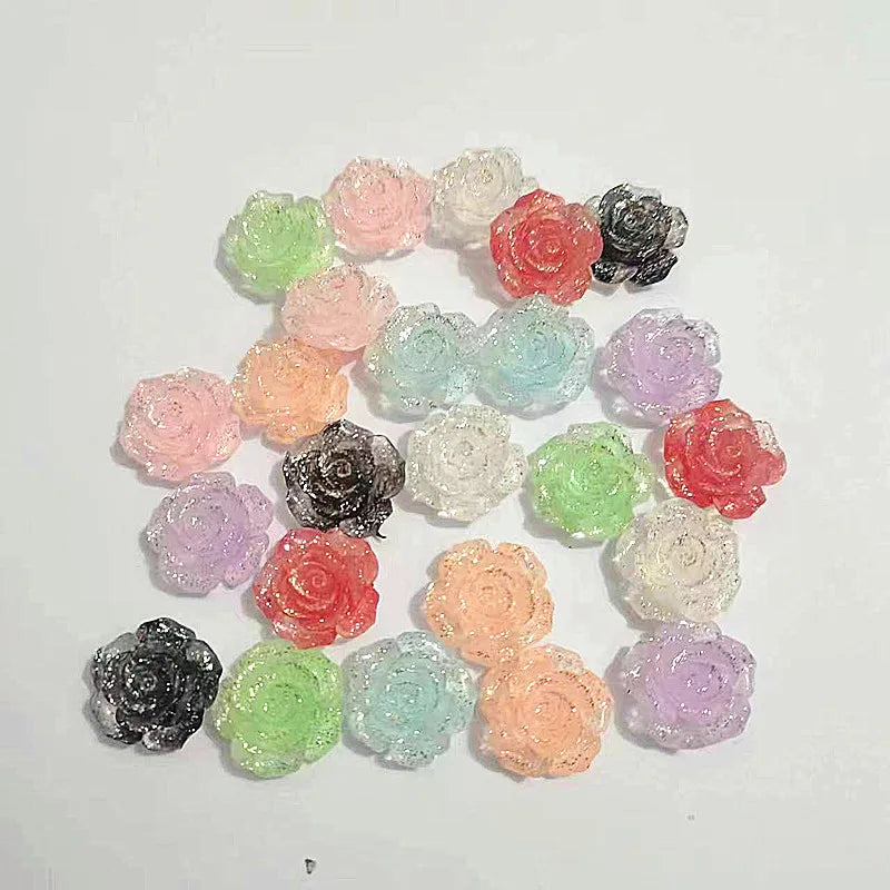 A collection of 50 small, colorful rose-shaped resin flowers in various shades of pink, green, purple, and red.