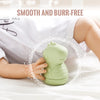 A light green silicone animal bath toy is shown being held by a baby on white fabric.