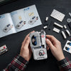 Hands hold a JAKI Horror Movie Puppet Model Building Set with Voice Recorder next to an open instruction manual.