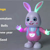 A pink and blue musical robot rabbit toy with long ears, standing on a surface.