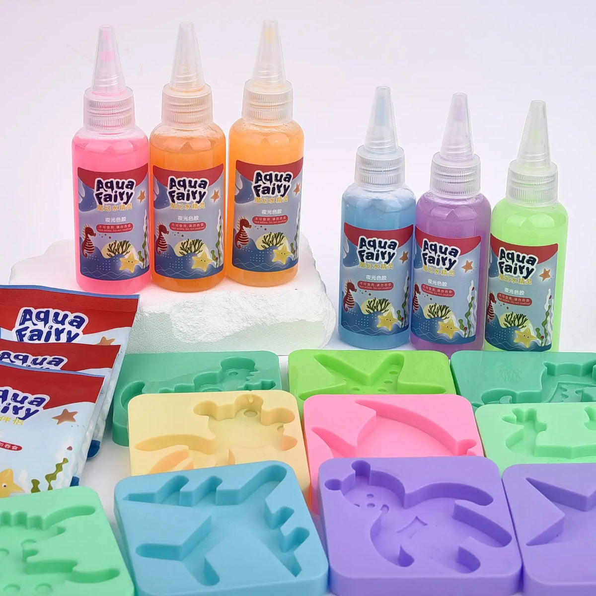 A collection of glow-in-the-dark liquid kits and silicone molds for a DIY craft kit.